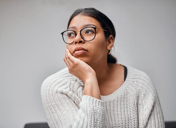 serious woman looking thoughtful