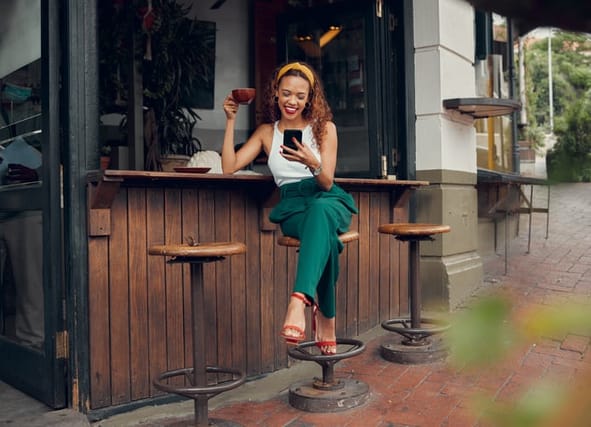 smiling woman texting at bar