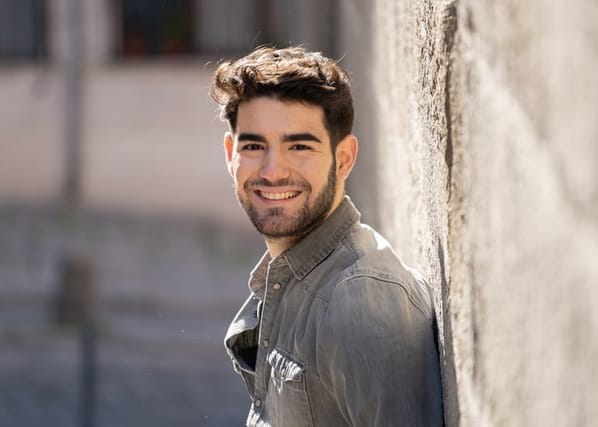 smiling man looking at camera outdoors