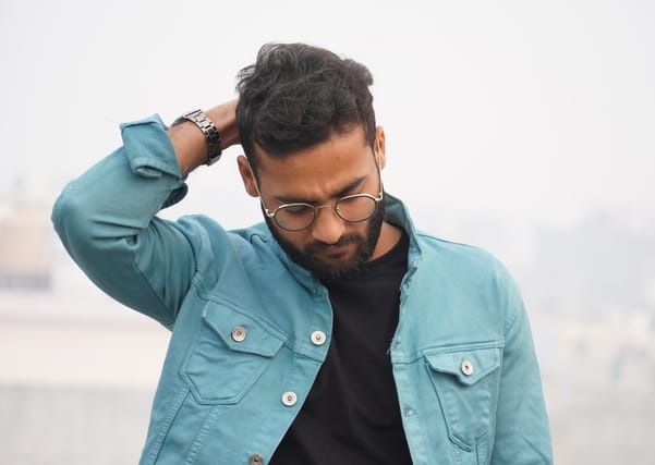 sad guy looking down outside