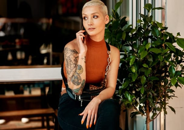 tattoed woman on phone
