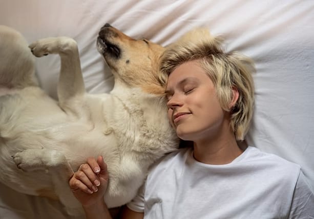 woman having a nap with her dog