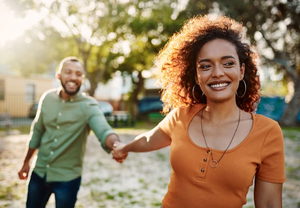 couple holding hands on sunny day