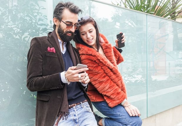 dramatic couple looking at phone