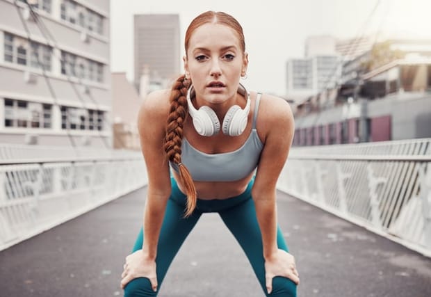 redhead woman out running looking determined