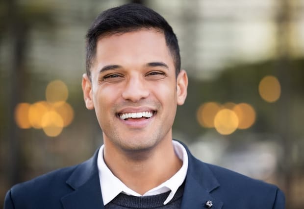 Businessman, happy portrait and outdoor city for leader success, corporate management or happiness vision. Male, smile and manager positive mindset energy or achievement in cityscape background