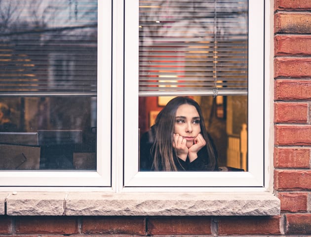 sad woman looking out window
