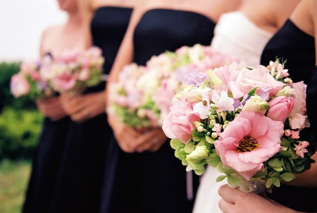 bridesmaids holding flowers at wedding
