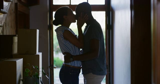 couple kissing in the shadows