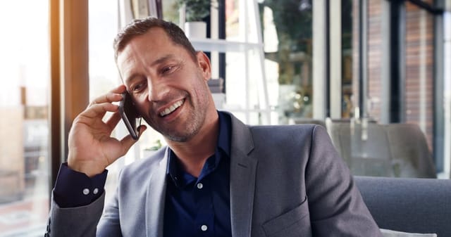guy smiling and laughing on phonecall