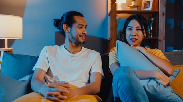 couple watching movie on couch