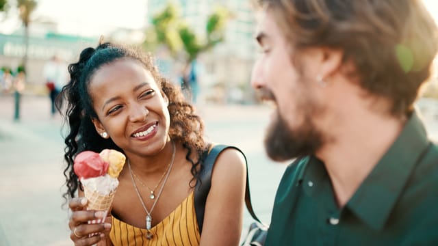 smiling multiracial couple on ice cream date