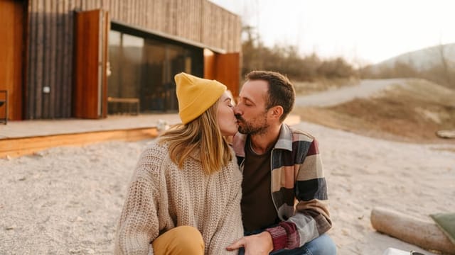 couple kissing outside in autumn