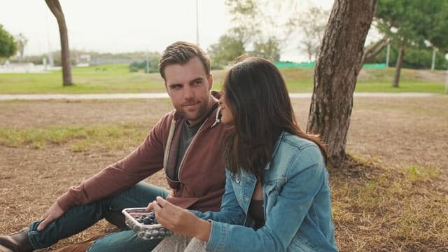 Woman and man enjoying dating outdoors in the park
