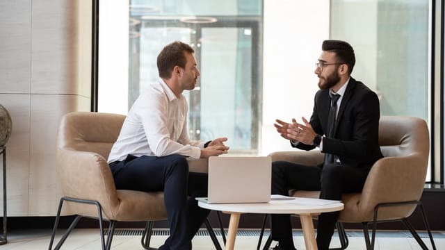 two businessmen talking at office