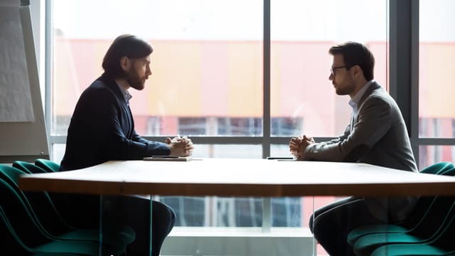 two male colleagues having serious conversation