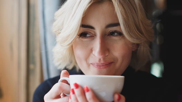 young woman sipping coffee