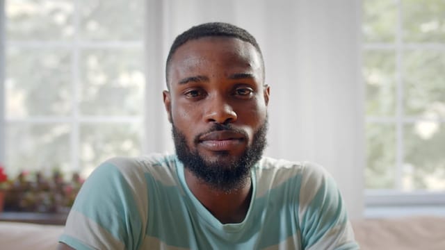 Man at home looking depressed.