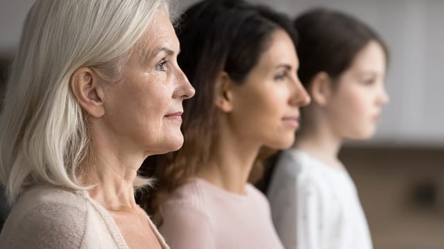 Side profile of three women from different generations—boomer grandparents, millennial parents, and a young girl—standing in a row and looking ahead, symbolizing family connections and the importance of child supervision.