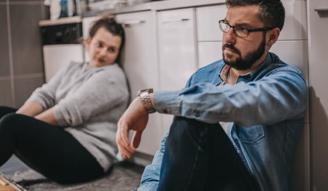 Young man and woman quarreling at home