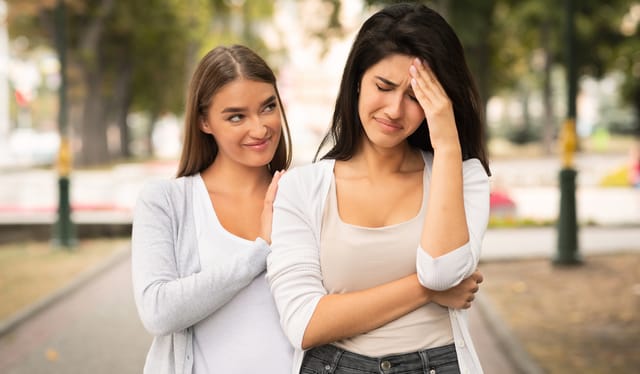 One friend being fake to the other and taking pleasure in her pain