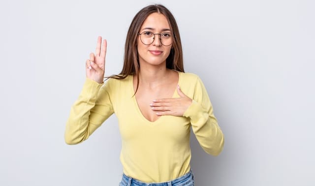 Woman displaying the trust sign.