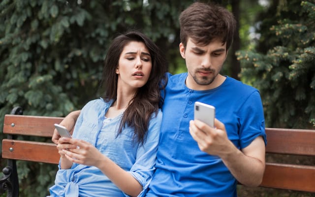 woman looking at boyfriend's texts