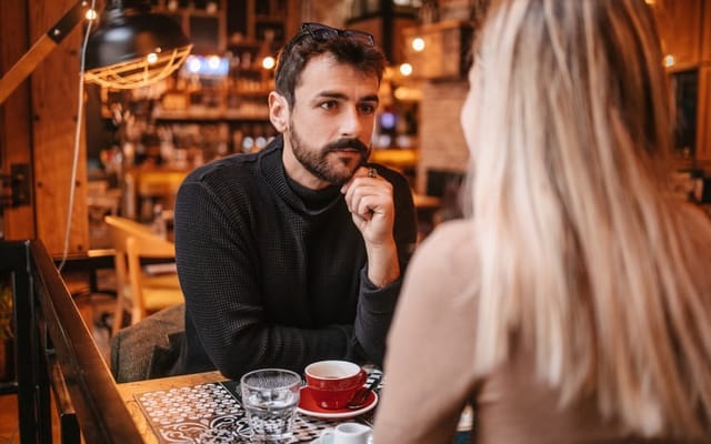 A young couple drinking coffee together on a date