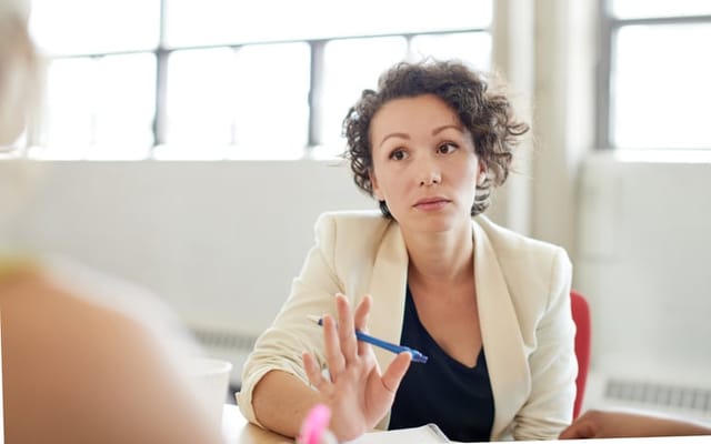 woman giving serious feedback in meeting
