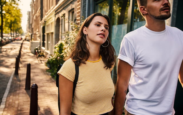 couple walking hand in hand down the street