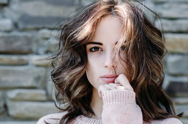 Portrait close-up of beautiful brunette young woman outdoors