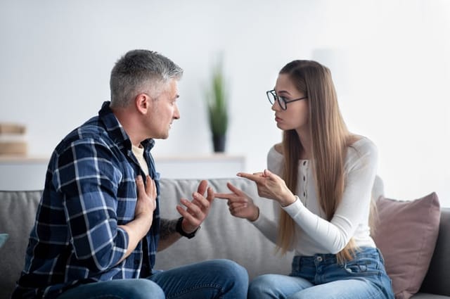 Mature married couple fighting, blaming and accusing each other, having relationship problem at home. Middle-aged man and his wife on verge of divorce or separation, arguing indoors