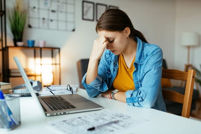 stressed out woman sitting at desk