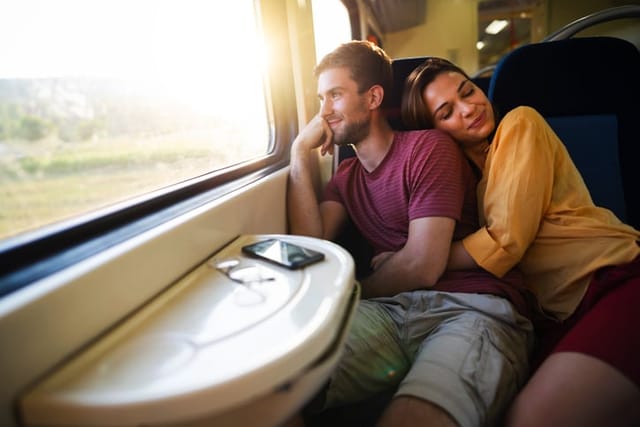 woman hugging boyfriend on train
