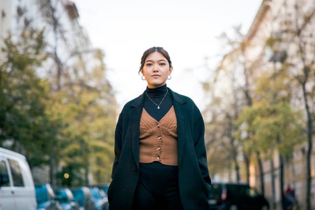 confident asian woman on city street