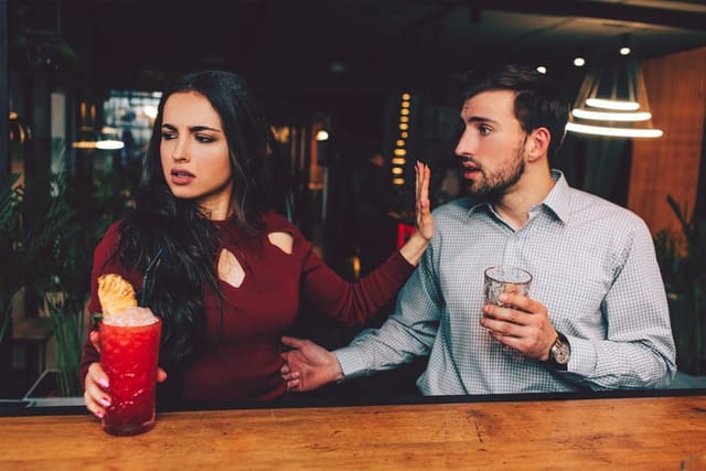couple in argument at bar