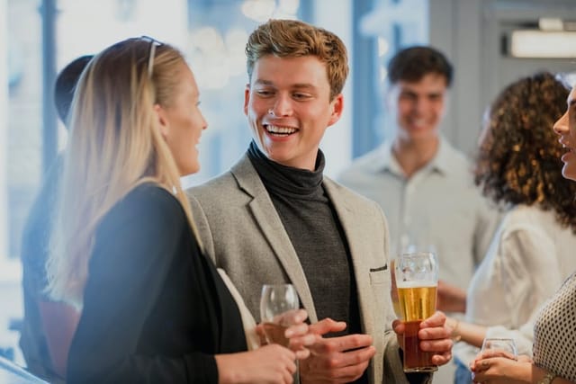 man talking to woman at networking event