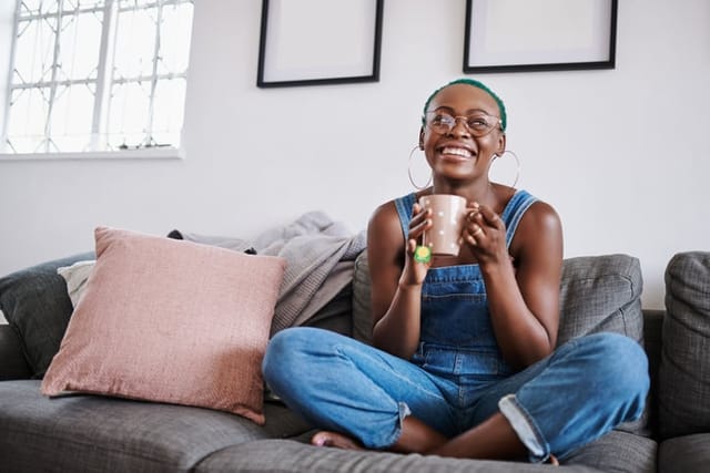 smiling woman sitting on couch