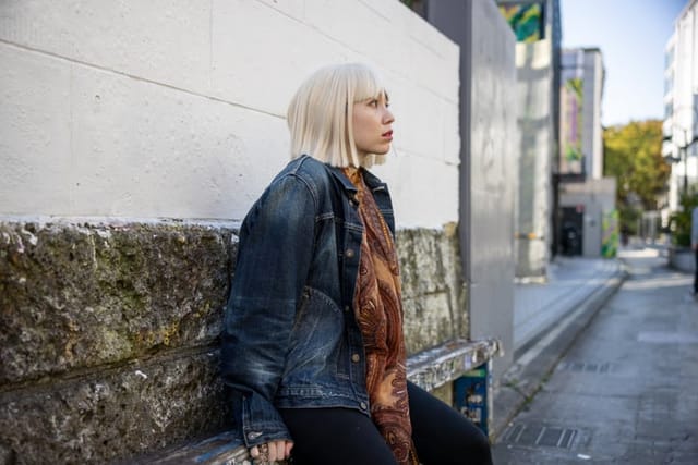 sad blonde woman outdoors