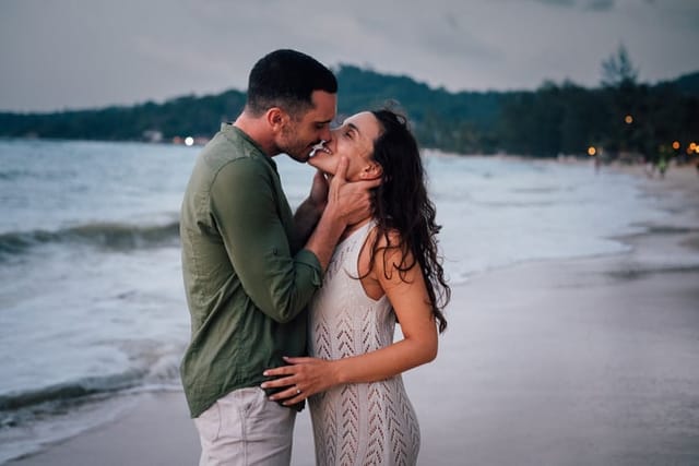 couple sharing romantic kiss on beach