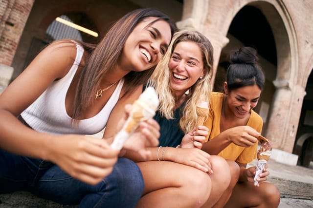 happy friends laughing with ice cream