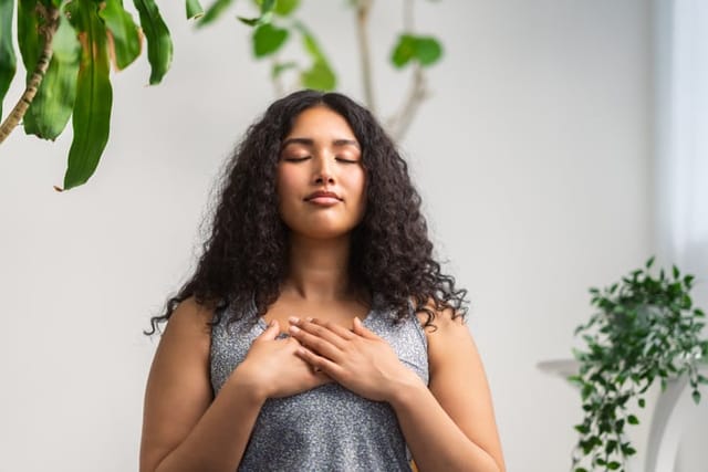woman meditating in calm room