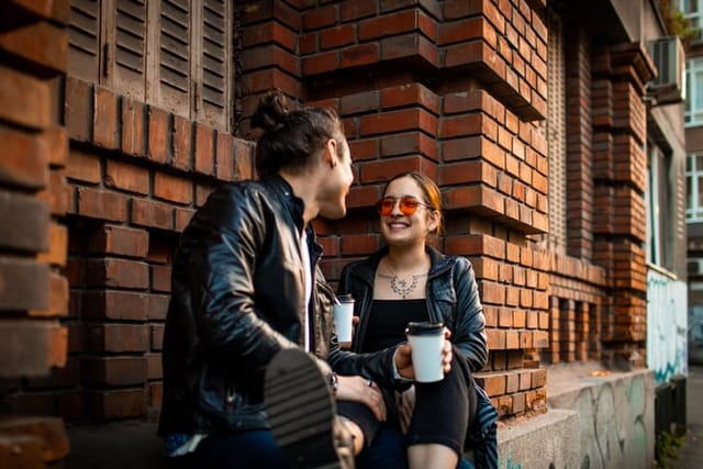 flirty couple having coffee in city