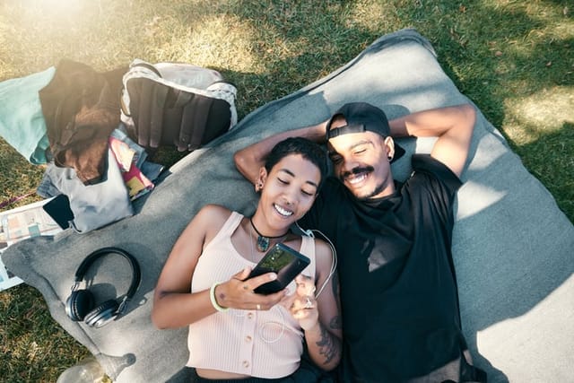 happy couple on picnic blanket