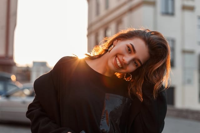 smiling woman sunlight outdoors