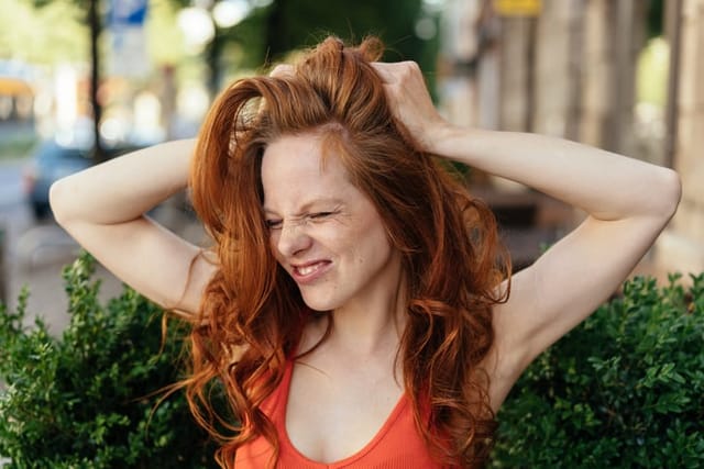 frustrated redhead woman outdoors