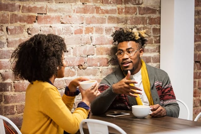couple having serious convo at cafe