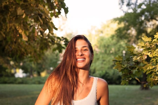 smiling woman in sunny park