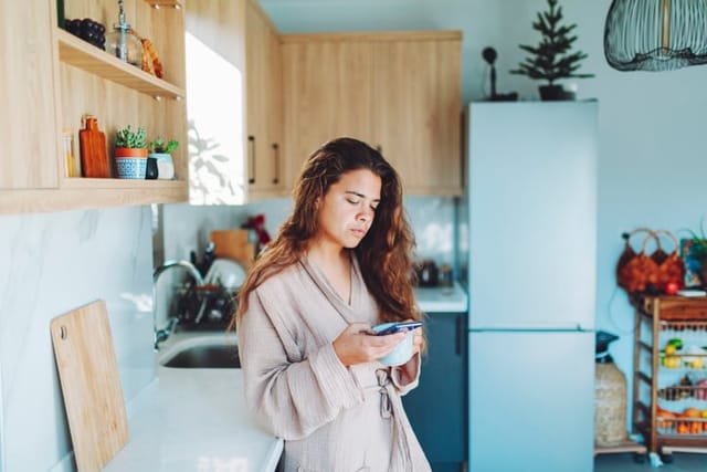 woman reading text with morning coffee