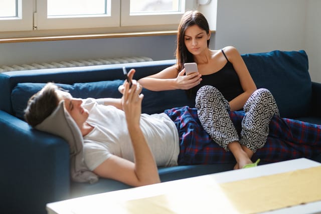 couple in pajamas on couch